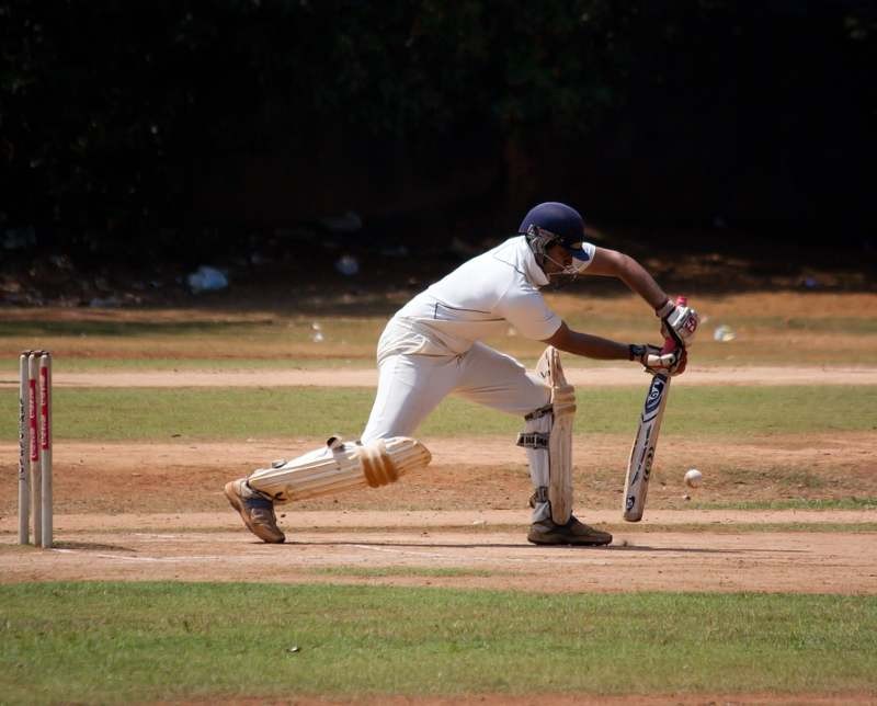 man playing cricket